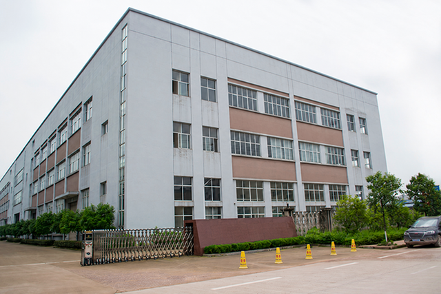 Exterior of a manufacturing building with an entrance gate