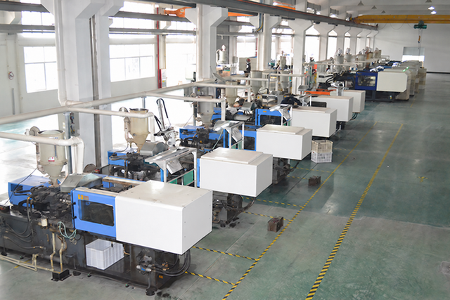 Moulding machines arranged along a factory aisle