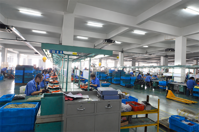 Workers assembling tools at a production line